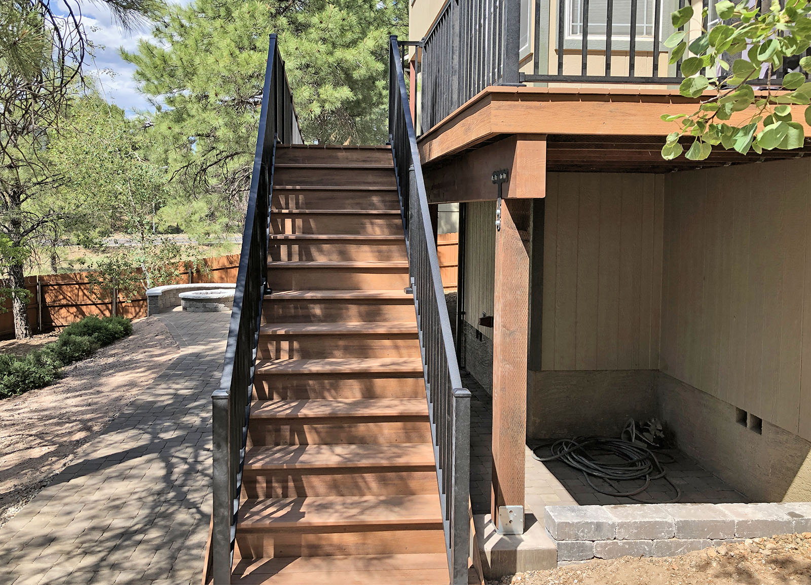 Stairs built with Trex Transcends Tropical color "Tiki Torch" and Trex Signature Railing in Charcoal Black