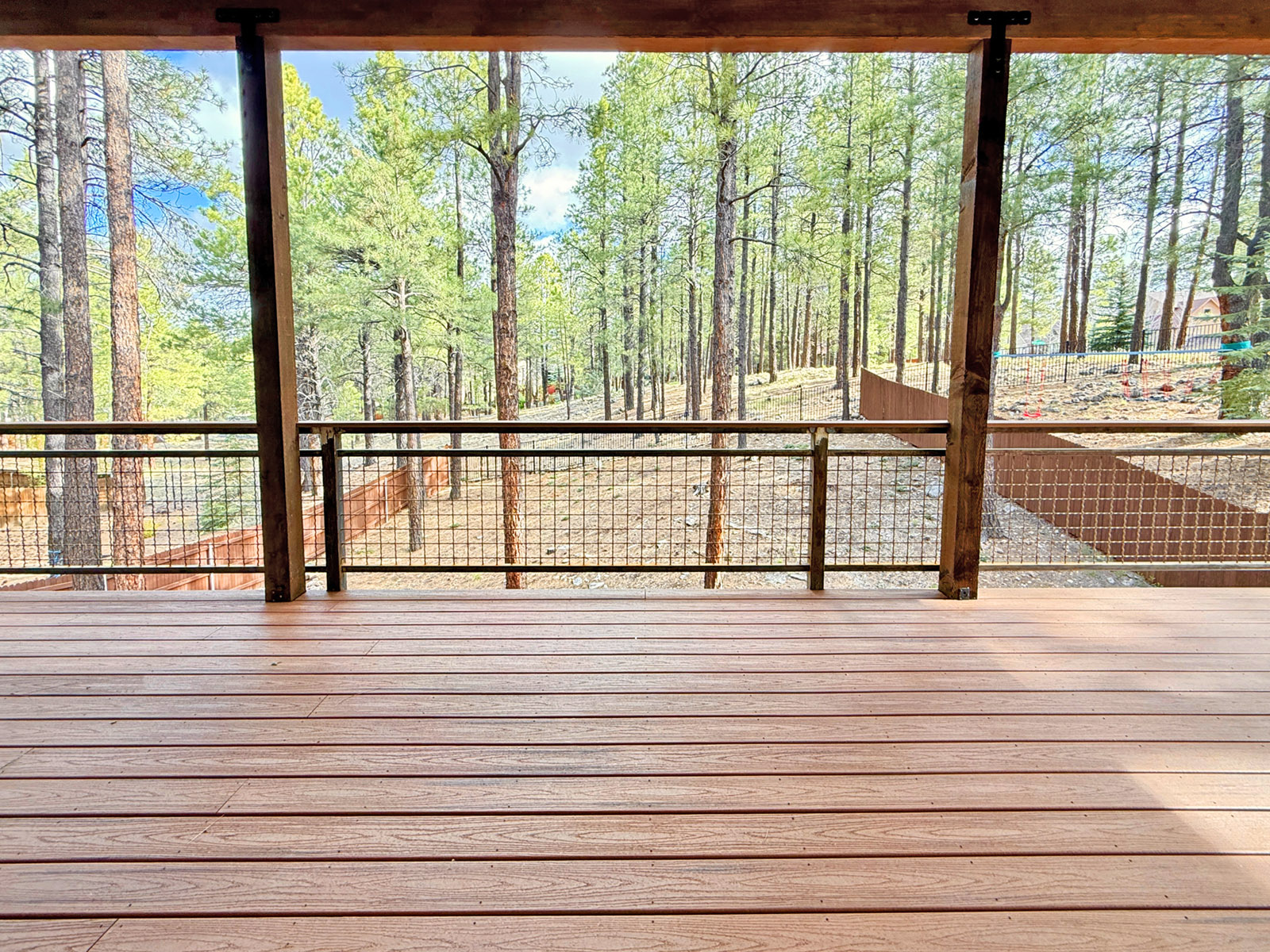 Trex with rusted railing Trex deck in Flagstaff Arizona with a rusted metal railing overlooking the forest.