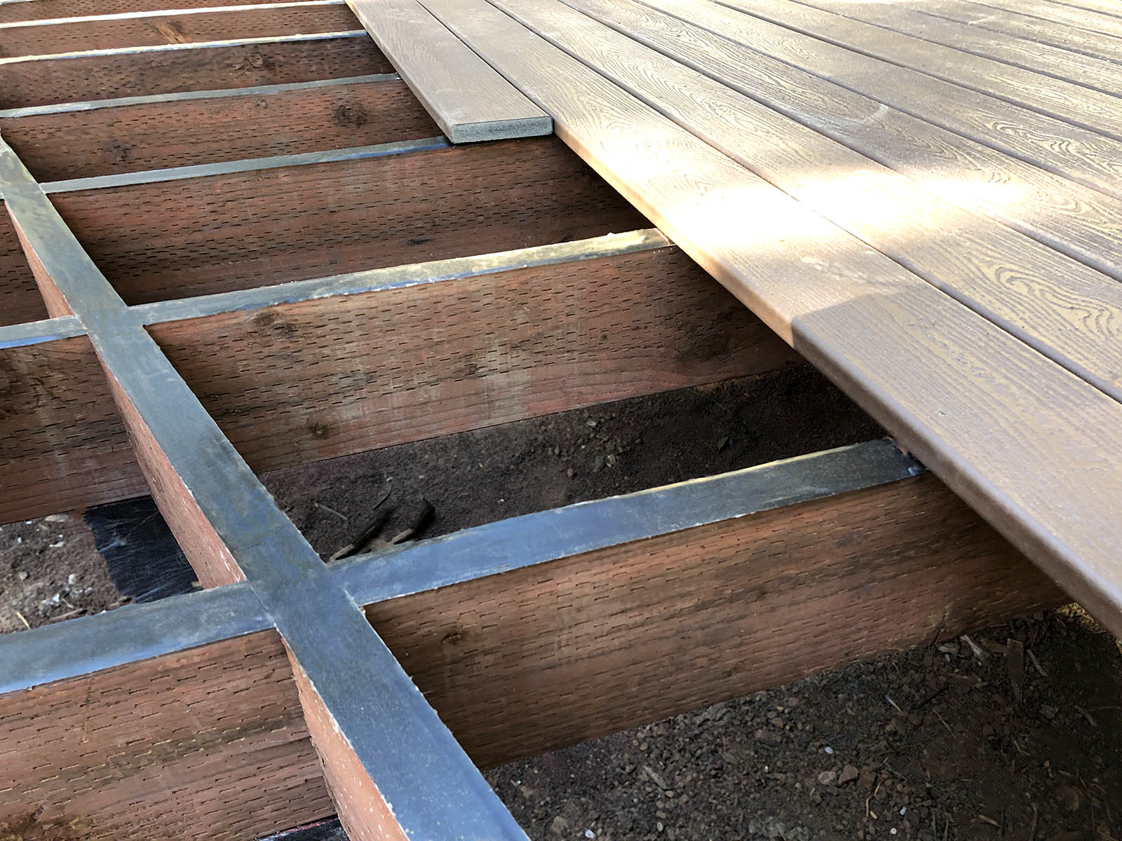 Installing Trex Protect deck tape on the tops of deck joists