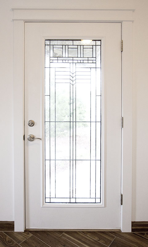 Interior side of a custom front door with full glass and craftsman trim