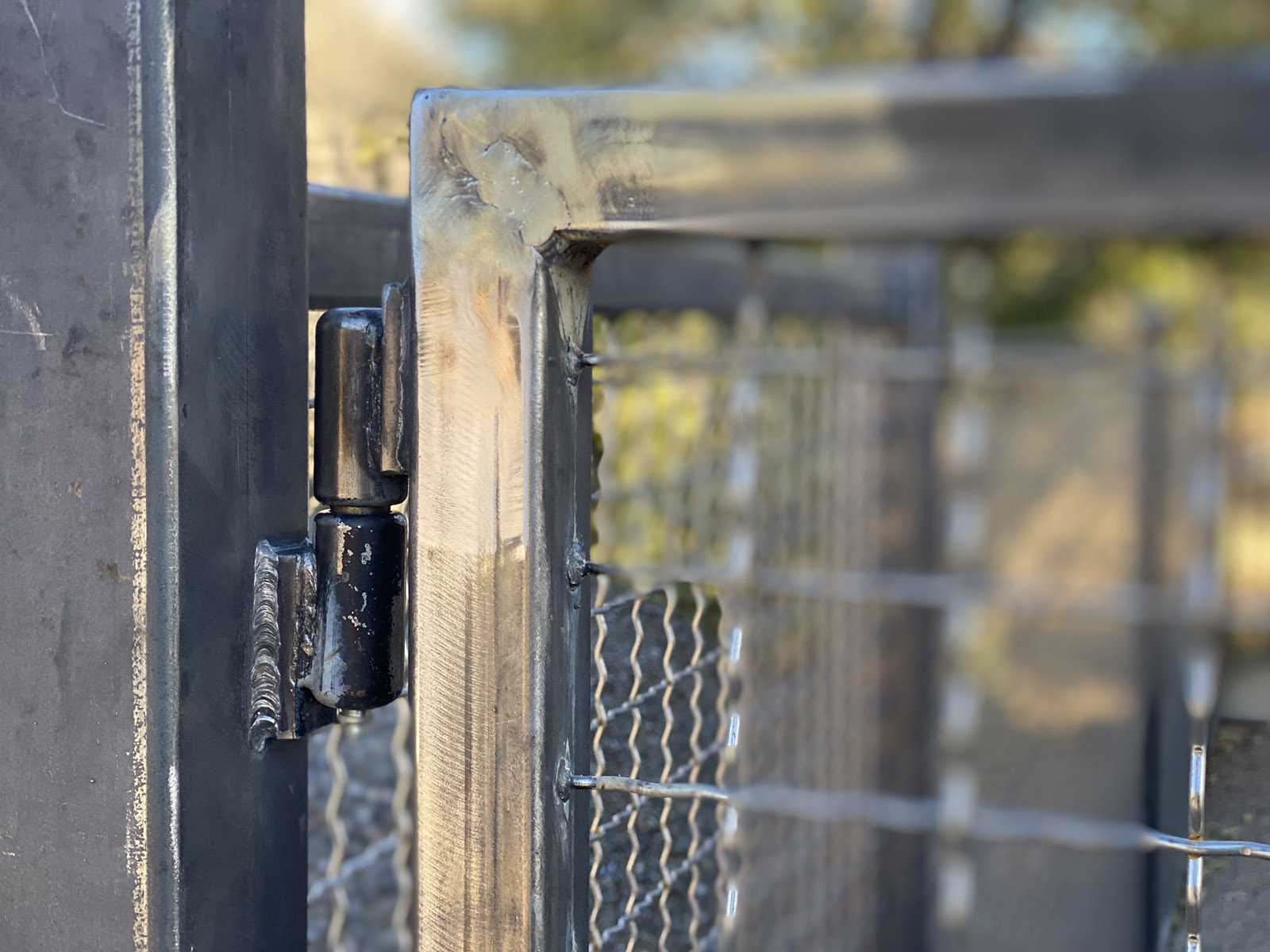 Fence gate with welded ball bearing greasable hinges.