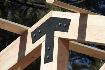 Closeup of custom steel brackets for large beam connections on deck cover job in Flagstaff Arizona